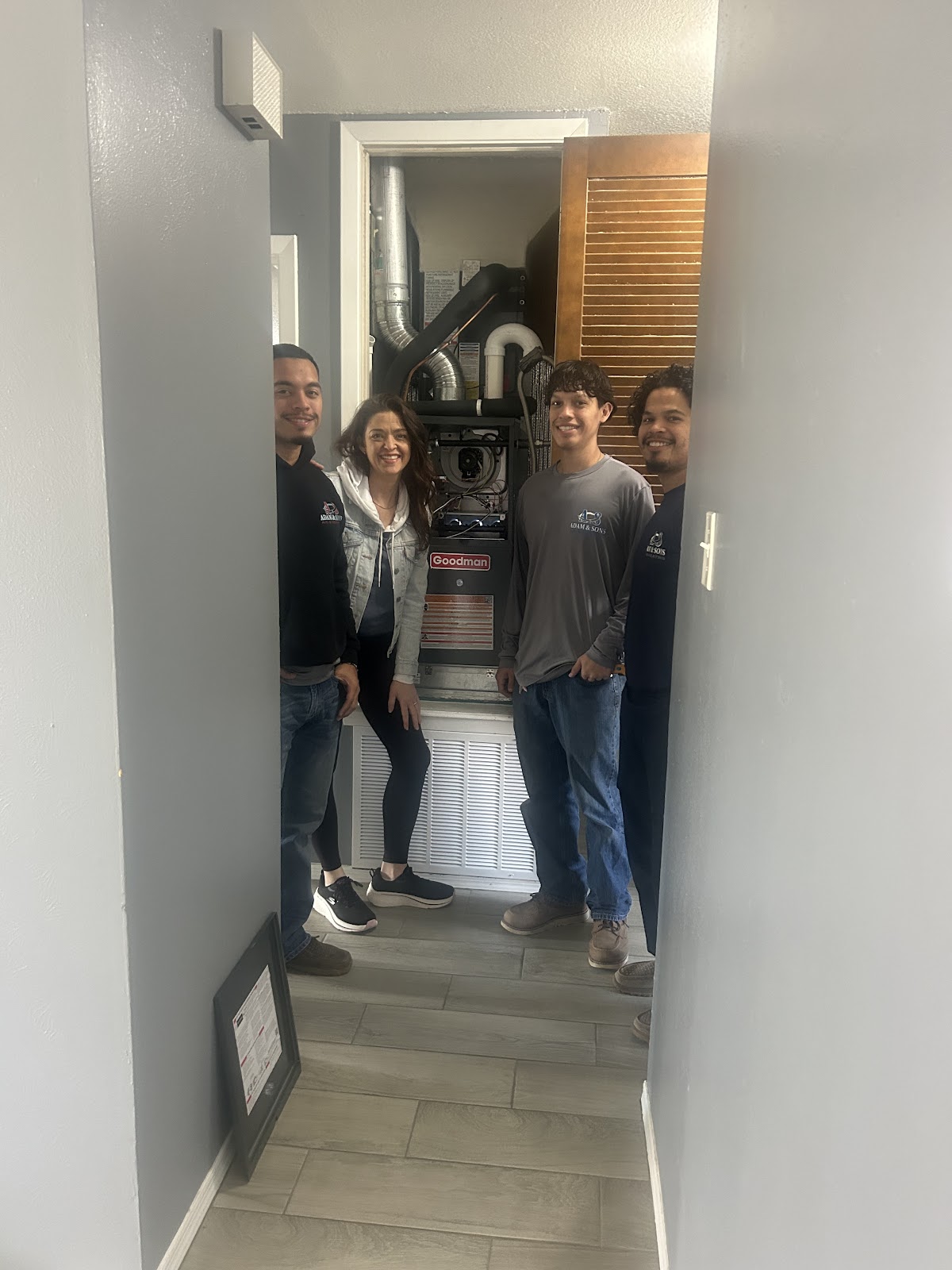 Adam and Sons HVAC team with a satisfied customer