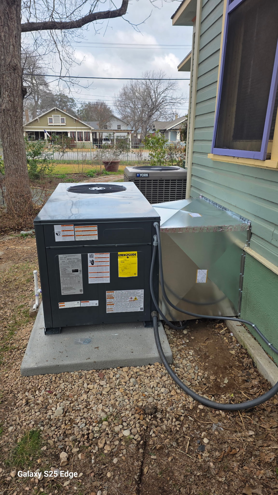 New Goodman AC condenser unit installed outside a home